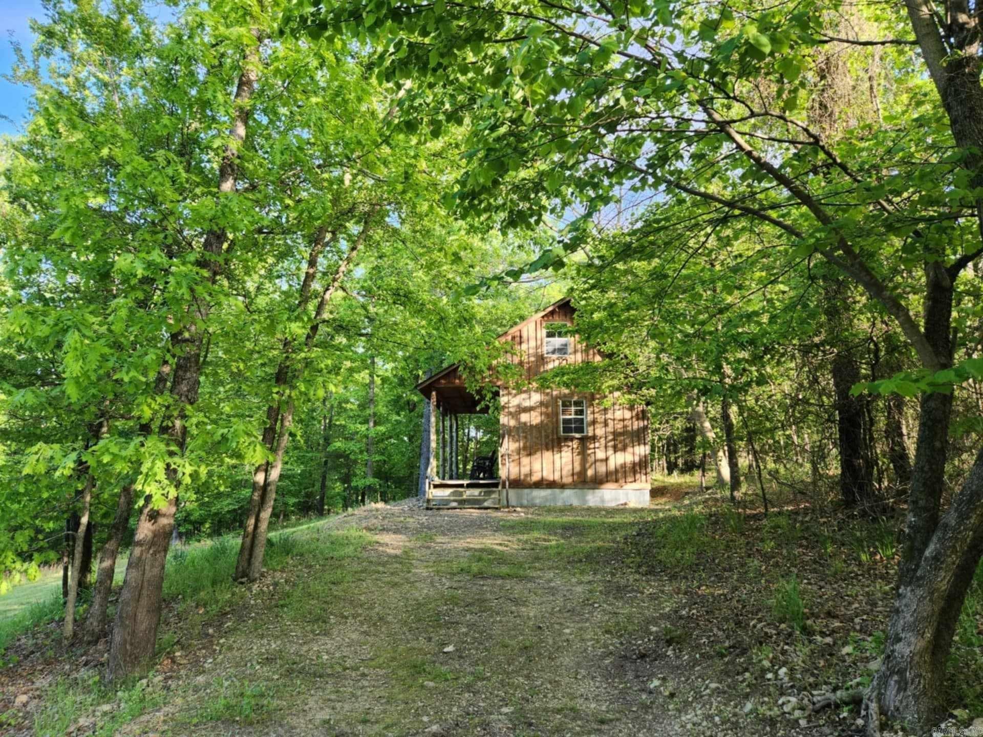 Gorgeous turnkey cabin with million-dollar mountain and woodland views located just minutes from the world renown Buffalo National River! Looking for the perfect getaway in the Ozarks to ride horses and ATV's or just relax on your private front porch watching spectacular sunrises? This well-designed cabin comes turnkey with a spacious loft bedroom and additional loft space perfect for use as an extra sleeping area for little ones or storage, high vaulted ceilings, timeless all wood interior, well-appointed eat-in kitchen, and a large bathroom with walk-in shower. Beautifully furnished and move-in ready! This river area has so much to offer, besides floating, kayaking, and horseback and mountain bike riding; there is one of few Drive-in Movie Theatres, delicious eateries, boutique shopping, Raccoon Springs Park and lake for Trout fishing, AR Game and Fish trails, and for avid hunters or nature lovers, an abundance of white-tail deer, fowl, and small game! Not only is this cabin a great place to call home, but it is also perfect for a weekend mountain getaway, hunter's retreat, or vacation rental! Come live the dream!