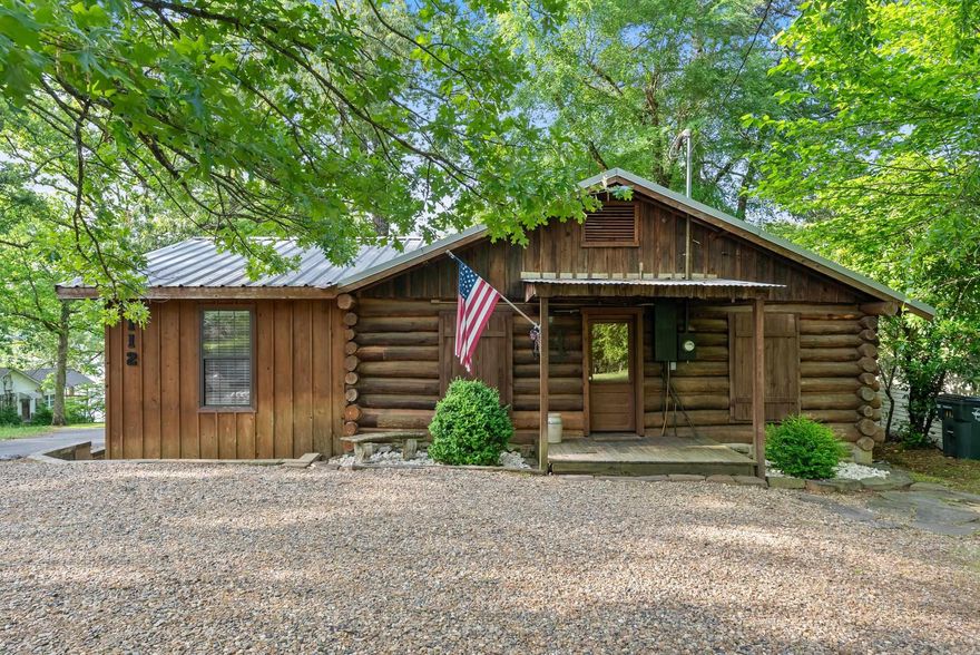 Charming Log Cabin Retreat on Lake Catherine – 112 Fairchild Point in Hot Springs. Discover the perfect blend of rustic charm and modern convenience in this stunning log cabin on the shores of beautiful Lake Catherine. Nestled in a serene, wooded setting, this 3-bedroom, 1.5-bath home offers cozy comfort and lakefront living just 15 minutes from Oaklawn Racing & Casino and all the attractions of downtown Hot Springs. Step inside to find a warm and inviting interior with vaulted ceilings, a wood-burning fireplace, and tasteful updates throughout. The living and dining area flows seamlessly into a well-appointed kitchen, making it ideal for relaxing weekends or entertaining guests. Enjoy your morning coffee or evening sunsets from the spacious deck overlooking the water, and take full advantage of your private boat slip for endless lake adventures. Whether you’re seeking a full-time residence, vacation home, or short-term rental investment, this cabin checks every box.