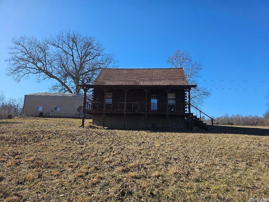 2 bed 2 bath log cabin sitting on 20 ac M/L with 9 ac m/l of hay field. 30x40 concrete floor, climate control, shop with a half bath. Several other out buildings for storage.