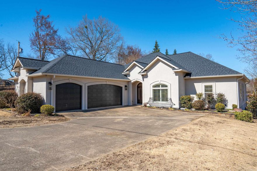 Escape to elegance and tranquility. This stunning one level gated lakefront home offers a beautiful view of Lake Hamilton, privacy and luxury. This meticulously designed property blends sophisticated living with natural beauty. This 4 bedroom, 2 bath, home features a gorgeous master suite with a walk-in closet, jacuzzi tub and tiled shower. The main living area has a fireplace, vaulted ceilings and large windows that fill the space with natural light. Step outside to your 12x40 veranda and enjoy direct access to your new boardwalk and covered boat dock with lift. Great for boating, fishing or soaking up the sun.  A treasure of lakefront living.