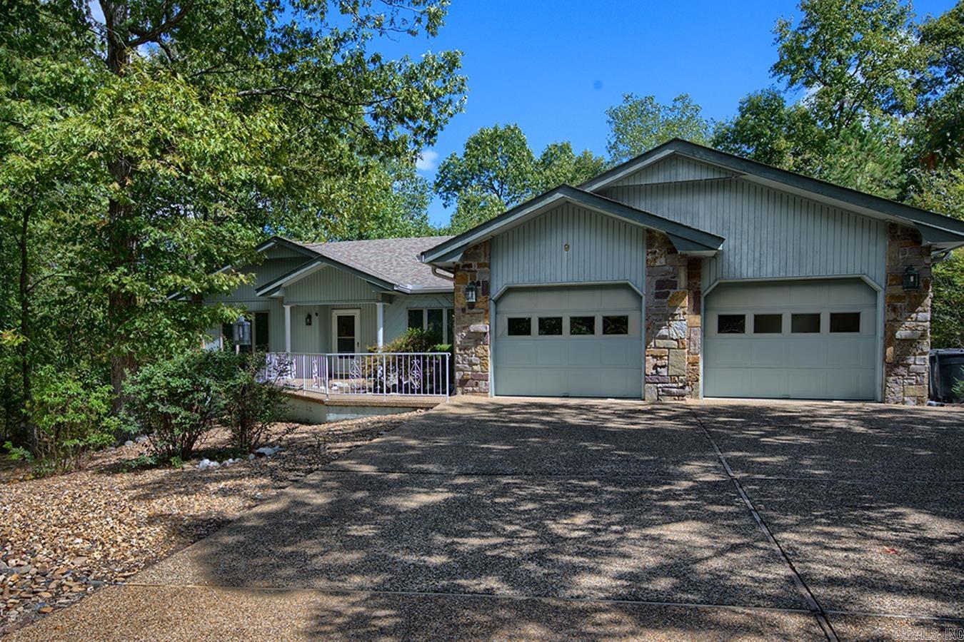 This is the one! Location, ambiance, floor plan, and price make this 3 bedroom 2 and one-half bath home highly desirable. Step inside & experience the bright, open-concept living/dining area, native stone fireplace, and large kitchen with lots of cabinetry ~the perfect setting for entertaining or relaxing with family. On one side of the home is the spacious primary suite and through the Great Room to the other side is the guest bathroom and guest bedroom/ home office area. Down the stairs to the lower level you'll find 2 additional rooms. One is the perfect open space for a game /media room or private guest quarters. The other area/ workshop is just waiting for your imagination! Sitting on the expansive deck surrounded by nature or entertaining guests at your new residence will be "just what the doctor ordered"!