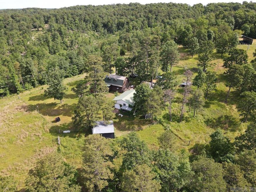 ChatGPT said: Tucked in the scenic Ozark hills, this peaceful property offers privacy, rolling terrain, abundant wildlife, and water features. The charming log home includes a full kitchen, living room, bathroom, and a covered deck with views. Upstairs features a large master suite with a bonus office space. A spacious deck is perfect for entertaining. Outbuildings include a huge metal shop, loafing shed, chicken coop, storage buildings, a fenced garden, and a large wood barn. Extensive cross-fencing is ideal for livestock. Wildlife thrives thanks to diverse native vegetation, and a powerful year-round spring originates on-site. Trails lead to a valley with a second spring and multiple potential building spots. Just minutes from Huntsville and Green Forest, with easy access to the Kings River, Eureka Springs, and Beaver Lake. This property is a dream for hunters, nature lovers, or preppers.