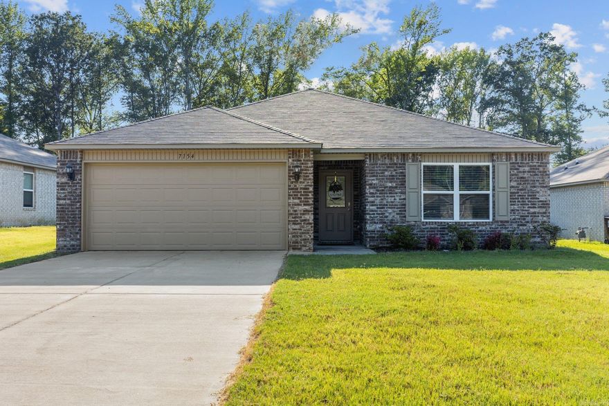 Welcome to 7154 Woodsgate Cove. Nestled in the cul-de-sac of Woodsgate Cove, this home features 3 spacious bedrooms and 2 bathrooms, providing you with an ample space and comfort.  The primary bedroom offers a large walk-in closet and soaking tub/shower combo.  Luxury vinyl flooring throughout the common areas and raised 9' ceilings.  Step outside and enjoy your covered back patio and large backyard that backs up to a peaceful wooded area providing a quiet & private area. Built in 2020.  Qualifies for Rural Development.  Don't miss out on the opportunity to own this gem!