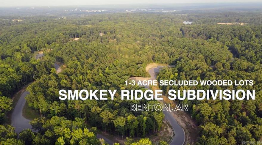 Smokey Ridge Lot 14 - Sloped lot covered in hardwood trees.  Perfect for a walkout basement house plan.  Smokey Ridge Subdivision has secluded lots nestled among mature hardwood trees with blooming Dogwoods. One of the highest points in Saline Co with rolling hills gives way to scenic views. Subdivision is adjacent to the AR Natural Heritage Preserve area with hiking trails to the river. 1-3 acre lots. Private single entrance. City water with fiber internet. Benton's newest elementary and middle schools nearby. Pick your lot and start building your dream home today. Exit 114 to W. Jackman Trail to Johnson to Smokey Ridge Rd.