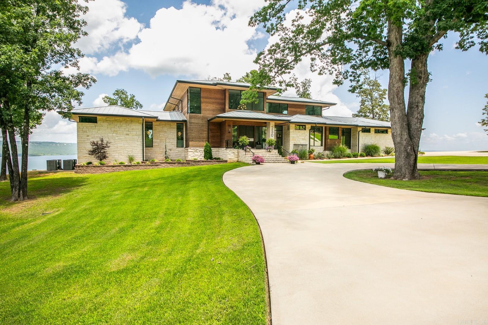 Heber Springs - Stunning lakeview estate on 15 acres w/ private, gated entry. Built in 2022, this 4,058 sq. ft. home has 5 bdr./4.5 baths & a panoramic view from every room. The two downstairs guest bedrooms open to a large patio w/ its own fireplace. In addition to the 4/4.5 home, there is a large in-law suite w/ a handicap friendly bathroom, kitchenette, and its own small patio. There is a generator & safe room. The kitchen has upscale appliances & large walk-in pantry. Master bedroom has electric blinds (as does the living room), & a retractable TV, along w/ a patio. The master bath has heated floors, a walk-in shower, a soaker tub, & his and her closets (with vanity for her). The upstairs bedroom is actually its own suite w/ a seating area, full bath & sleeping quarters, in addition to the large loft at top of the stairs that holds two full-sized couches. In addition to the attached garage, also on the property is a 40ā x 50ā large shop w/ two 12-foot garage doors, a half bath w/ washer & dryer, a heated/cooled office, & more storage ā not to mention the same the same great lake view as the home! 16.49 acres, next door to this home, is currently for sale as an option.