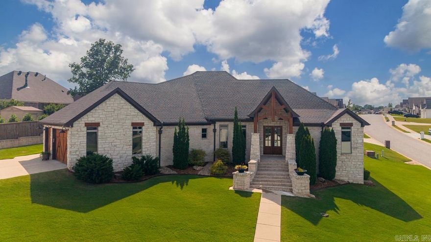 This Exquisite modern french country single story home is a dream.  You will love the exterior with its cypress and stone accents, along with the wood look garage doors.  Entering the home, the beautiful hardwood floors and the open living, kitchen, and dining space greet you.  The kitchen is every cooks delight with its Professional side by side refrigerator (stays), hickory cabinets, large island, dual ovens and gas cooktop. Washer and dryer also convey.  In addition,  three of the four bedrooms have ensuite baths. Other features of the home include wide doorways, a whole house generator, floored attic accessed by walk up stairs,  sprinkler system, tankless hot water heater, wood plantation shutters and blinds, and two covered back porches.  Seller just refreshed all exterior staining of front entry, front doors, garage doors, and other exterior wood elements, as well as landscaping.  This beautiful, meticulously maintained home is ready for you.
