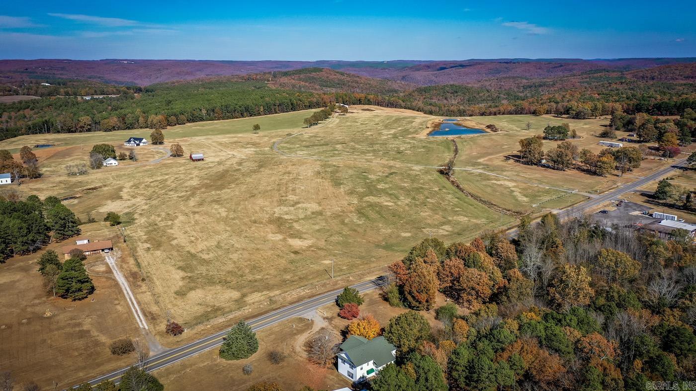 If you're looking for a large tract of pastureland, THIS IS IT! 100 ACRES. The panoramic views of this land and mountains are just breathtaking. Features 3 ponds, a natural spring, and a 40x70 new hay barn with a 20x70 lean-to. It's fenced and cross-fenced with all new fencing, new gates. Over a quarter of a mile of highway frontage on State Hwy 16. Also borders Stagecoach Rd. Ready for horses, cattle, whatever your country heart desires. A water line has been installed from the road to the hay barn with water access on both sides of the hay barn. Has two entry gates on the highway side. Produces approx. 1,000 round bales of hay yearly. Large pond stocked with fish. Plenty of wildlife roaming the property for the hunting enthusiasts. Conveniently located just outside of Fairfield Bay, which features 2 golf courses, restaurants, shopping, grocery stores. Over 90 miles of ATV/UTV trails. 6 miles to the nearest marina on Greers Ferry Lake. Minerals will convey. Agents See Remarks and Associated Docs.