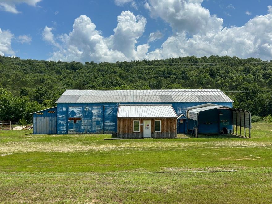 Commercial Opportunity: Highway Frontage with Expansion Potential... Located just outside the city limits of Hardy, Arkansas, this exceptional 5.4+/- acre  property offers unparalleled visibility and accessibility. With approximately 483 feet of highway frontage, it ensures maximum exposure to both commuters and vacationers. The property boasts two convenient access points from the highway, making entry and exit a breeze. A versatile 3,944 sq ft building features multiple garage bays, dedicated office space, and a restroom, ready for a variety of business needs. What truly sets this property apart is its ample parking and significant acreage, providing abundant space for future expansion or the addition of new structures. Essential utilities are already in place, including fiber-optic internet, a well, and electricity currently on site. Beyond its undeniable commercial appeal, this property has year-round creek frontage! Imagine the possibilities of building a home with the existing shop space already on-site, you could effortlessly combine comfortable your home with the convenience of an immediate workspace. Call today to view this unique property.