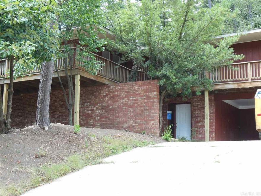 MID CENTURY MODERN IN THE TREES Great architectural style secluded in convenient mid-town location. Spacious dual level four bedroom, 2 1/2 bath home with hard surface floors throughout. Living/dining combination, nicely furnished eat-in kitchen, laundry room, lots of storage, 2 vehicle carport, huge patio, wrap around deck, fenced back yard. Call Marshall Peters & Assoc.  501-414-8340