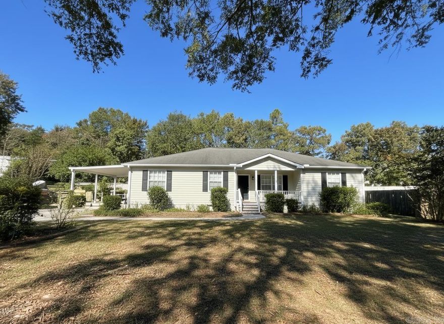 Welcome to this 3 bedroom, 2 full bathroom double wide mobile home located in Hummingbird Estates.  The home is on a permanent foundation.  The roof and hvac are 2 years old.  The home features a wood burning fireplace, back deck and front porch.  Also has a carport and storage building.  Neighborhood fishing pond. Out of city limits.  Lake Hamilton school district.  Sellers are in process of packing, so please excuse the mess.  There is brand new viynl flooring that sellers are leaving for new owners.