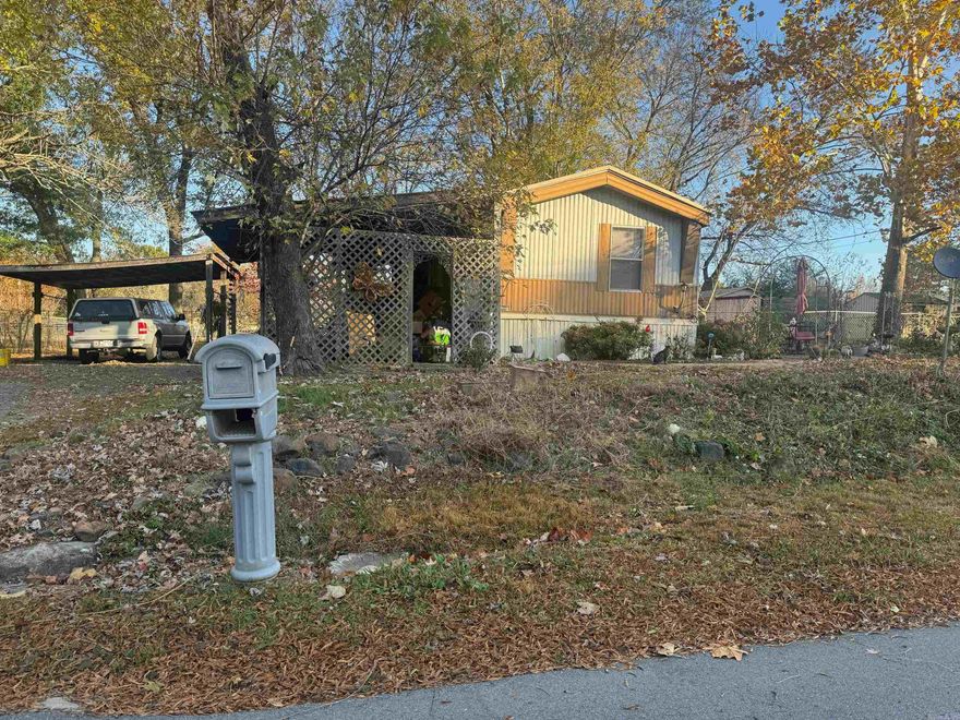 A well-kept mobile home with two covered parking areas, a storage shed, a covered front porch, and a covered back deck.  The property sits on a quiet dead-end road surrounded by beautiful trees and includes a nice garden area, providing a peaceful country setting. This property is listed also with other property as a packaged deal or sold separate in 25043553.