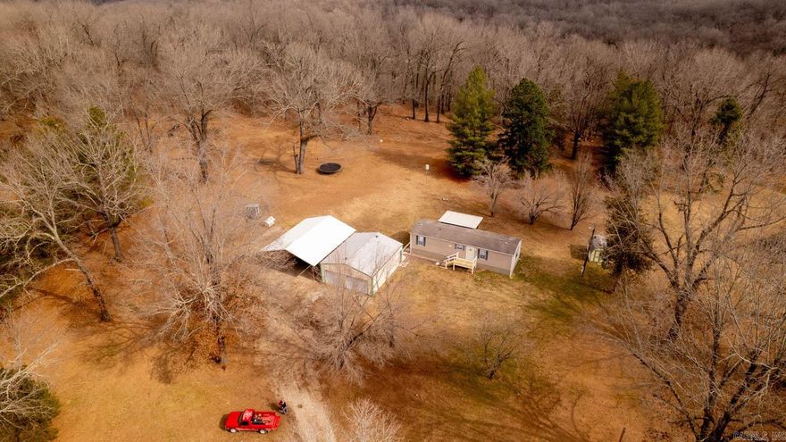 ATTENTION HOMESTEADERS, HUNTERS AND FISHERMEN! Here is a rare opportunity to own 8 flat, usable, unrestricted acres of outdoorsmen paradise with 700ft bordering Corp land and a gorgeous arm of Norfork Lake. Clear, pristine fishing and swimming waters down the short walking trail right out your back door. Immaculate and adorable move-in ready 2 bed, 1 bath mobile home with new flooring, new front porch, covered back deck, 25x30 shop, 2 car covered boat and toy parking and even a cute as a button 2-story unfinished tiny home with tall loft, all sitting on private acreage with just the right mix of pasture grass, good soil, shade trees, magnificent towering forest, fish and wildlife galore. Do what you want on your own slice of natural paradise with private well, plenty of storage space and lots of room to grow. Walk your kayak down the short path to your own private fishing spot, out the Bayou waters that connect to Norfork Lake. Only a six mile drive to Fout Marina, boat launch and only 20 mins to all you need in Mtn Hm!