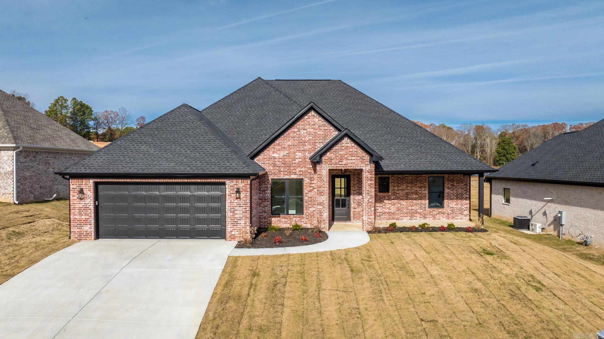 Sleek, stylish, and smartāthis gorgeous all-brick, one-level new construction home blends modern design with everyday functionality. Featuring 3 bedrooms, 2.5 baths, and a dedicated office space just off the foyer, this home was built for both comfort and versatility. Step into the open-concept layout where the kitchen stuns with quartz countertops, a large island, soft-close custom cabinetry, gas stove, and a walk-in pantry. The spacious laundry room is oversized for convenience and storage, while additional closets throughout the home keep life organized. Each bedroom is generously sized with large walk-in closets, including a Jack-and-Jill setup. The primary suite is a true retreatāhighlighted by a bathroom with high-end finishes and a closet larger than most bedrooms. Other features include fiber internet, natural gas, a tankless water heater, and clean, contemporary finishes throughout. Priced to move and ready for its first homeownersāthis is modern living made easy