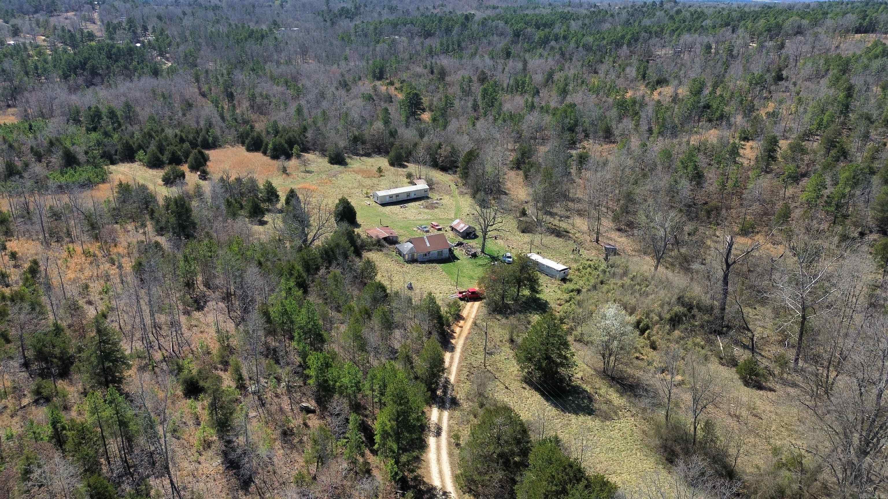 65 +/- Acres with Creek, Pond, and Fixer-Upper Mobile Home in Arkansas! This 65 +/- acre property in Oxford, Arkansas, offers a mix of open fields and wooded areas, making it an excellent opportunity for hunting, farming, or building. The land features a year-round spring-fed creek, a pond, and large fields ideal for livestock or recreational use. A 960 sq. ft. single-wide mobile home, built in 1988, sits on the property and is livable but needs some work. Additionally, there is an old house that will need to be torn down. Utilities are already in place, including power and city water. Located just minutes from Oxford, this property provides a great combination of privacy and convenience. Whether you're looking for a hunting retreat, farmland, or a homesite with utilities already in place, this acreage has plenty of potential. PRICED TO SELL AT $149,900.