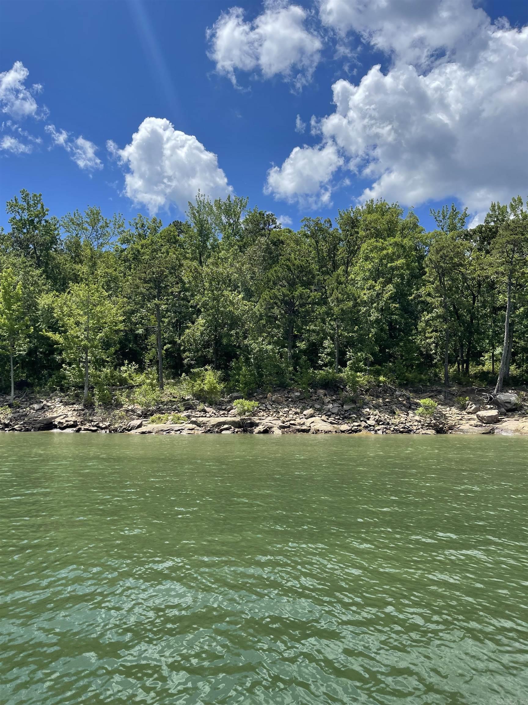 LAKEFRONT/LAKEVIEW lot with a great white line location. A must-see for the lake dwellers. Open up view w/clearing trees. Gentle slope/easy walk to the water. Unrestricted. Build a tiny home, a cozy cabin, or your dream home. If you like seclusion, this is the lot for you. Not a lot of boat or car traffic. Survey and septic permit on file. Close to Hill Creek Marina.
