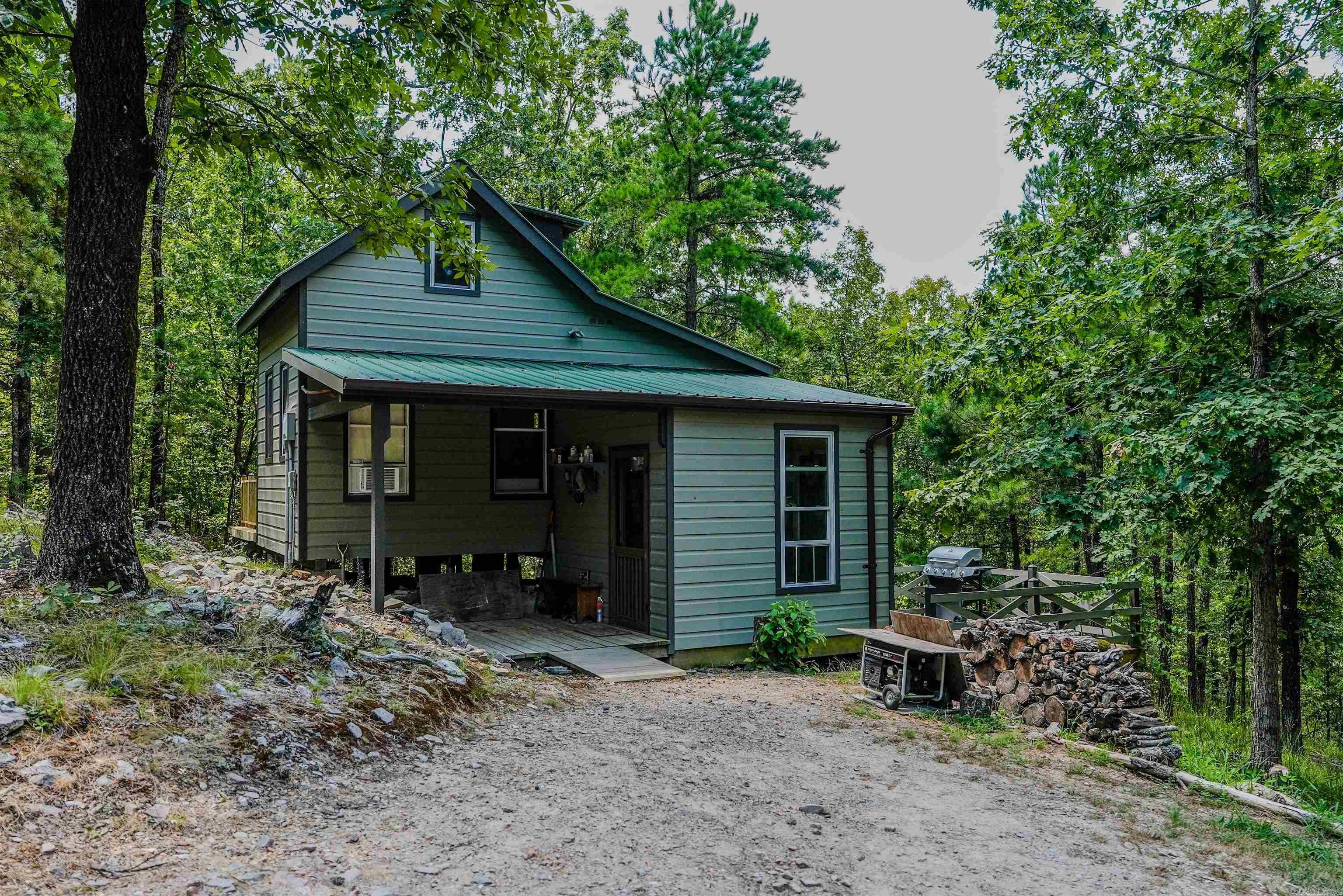 Hand built Cabin sitting on 8 acres, loft bed, living room, kitchen, with two decks that having you feeling completely immersed in nature! This home isn't just real estate it's art you can live in! The owner is a craftsman who built this has his escape from a busy world. Step into this one of a kind property that the builder calls his refuge! This one you truly have to see to believe. Agents please see remarks.