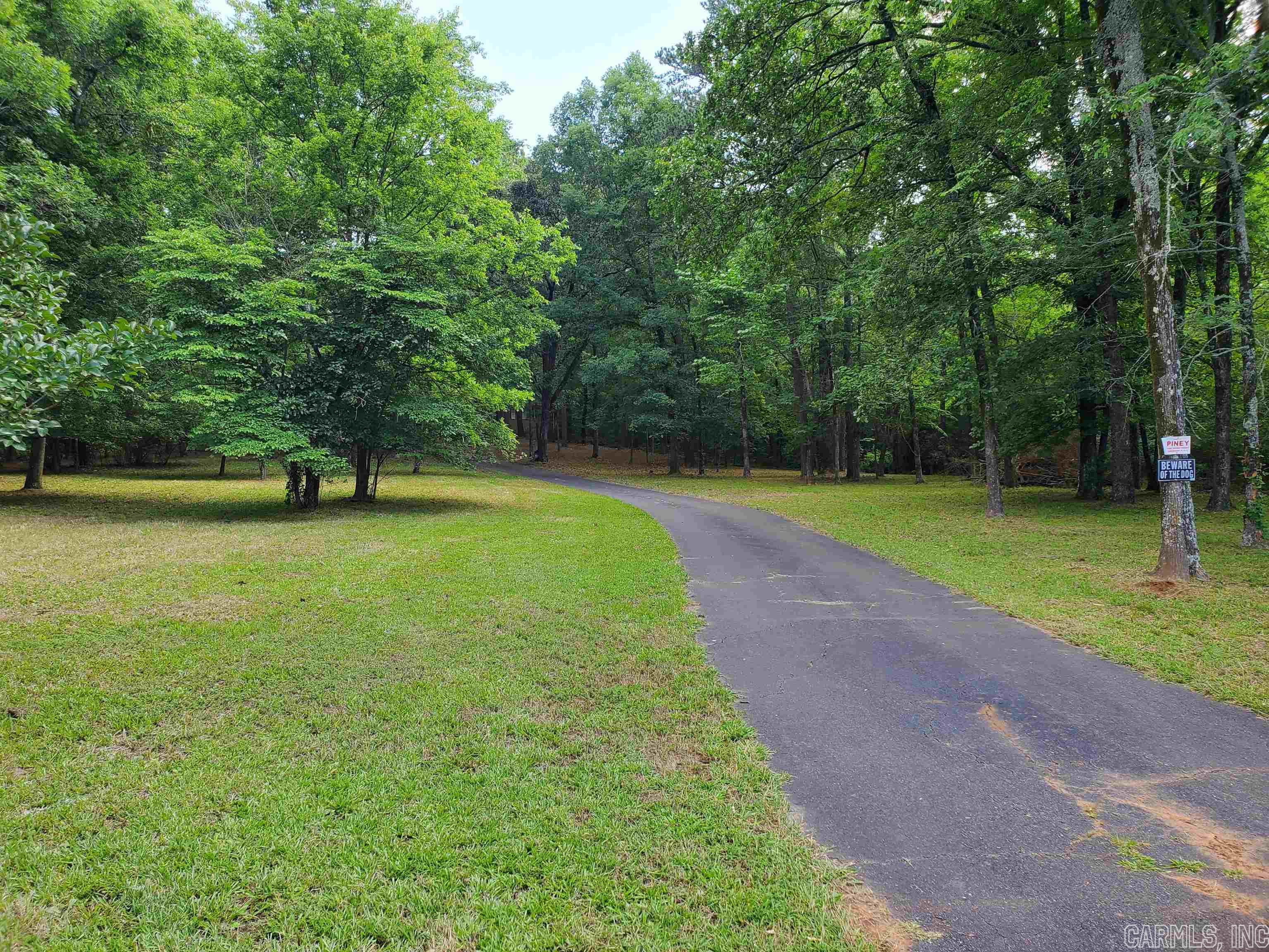 Beautiful 7-Acres on Cedarglades Rd., Desirable Location with a 3-bed/2-bath Brick home, Clean and Solid, 2 - (Year Round) Artesian wells feeding a creek that runs through the property, Historical street curb rock used to come from an area close to this property, There is a 16kw natural gas Generac home generator, paved driveway, power and 2nd septic located on the property for a mobile home or second home site, Minutes to Lake Ouachita, Lake Hamilton & Downtown Hot Springs.