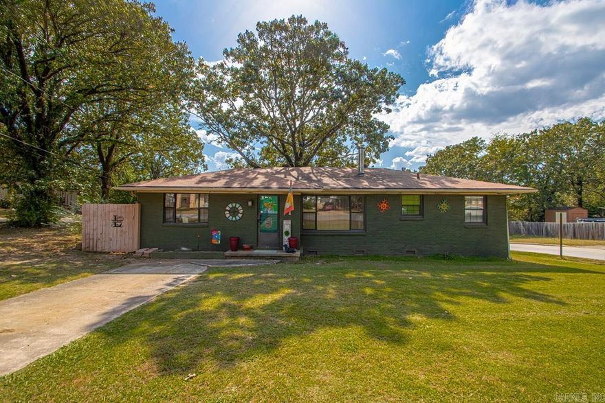 Located high on the hill.  A large corner lot, this homes dark gray exterior paint gives it a sleek, updated look, while the inside welcomes you with the warmth of original hardwood floors in the living room and bedrooms.  The kitchen has been updated with classic white shaker cabinets, new stainless steel appliances and a butcher block prep area that's both functional and stylish.  The dining room is currently being used as a home office-offering flexibility to fit your lifestyle.  Step through the side doors to enjoy outdoor living.  A deck overlooks  what could be a firepit area, and a stone path leads to a spacious shop or detached garage-perfect for hobbies, projects, or extra storage.