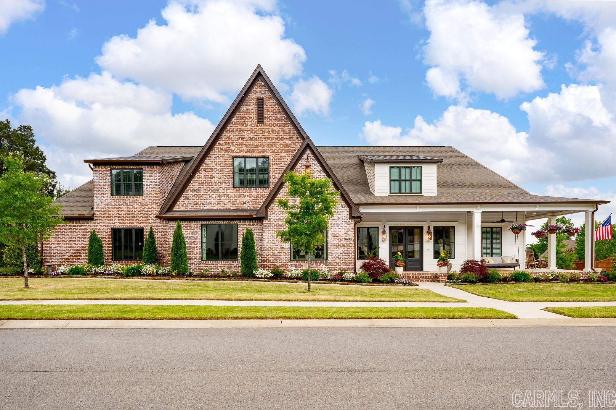 This Weatherstone home has a southern-style design on a .43-acre corner lot. It offers 4/5 beds, 4.75 baths, a 14ft coffered ceiling living room opening into a kitchen/dining area. The kitchen has custom cabinets, a 10ft island, and a Zline commercial range, with a butler's pantry featuring a custom pull-out cabinetry and ice maker. The master suite includes a vaulted ceiling, gas fireplace, 12ft sliding patio doors, custom coffee bar, and large closet with a dressing area. The house has a 3-car garage, custom landscaping, Zoysia grass, sprinkler system, and an outdoor kitchen with a fireplace, pool, and more.