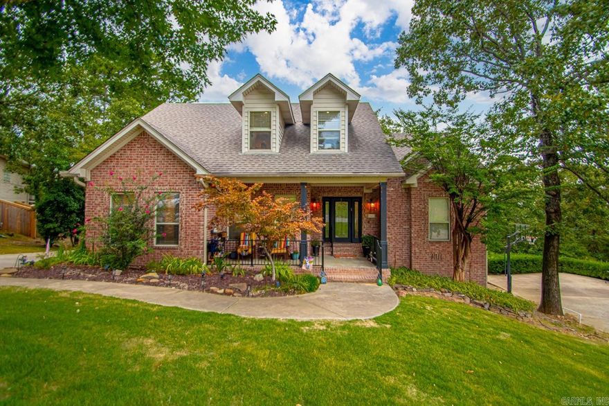 Nestled in Chenal Valley’s prestigious Duquesne community, this 2,535 sq. ft. home combines elegance with modern comfort. The chef’s kitchen, with stainless appliances, a gas range, sleek cabinetry, and designer fixtures, opens to the living spaces, where a double-sided fireplace creates a warm connection to the primary suite, complete with a spa-inspired bath, custom closet system, and private deck access.  Upstairs, a flexible retreat with a full bath and walk-in closet offers space for a guest suite, media room, or home office, while the outdoors impresses with expansive double decks, a built-in cooking area, landscaped yard, black metal fencing, and a custom dog ramp. Hardwood floors, updated lighting, quality finishes, and a side-loading garage complete the home, providing both style and everyday convenience.