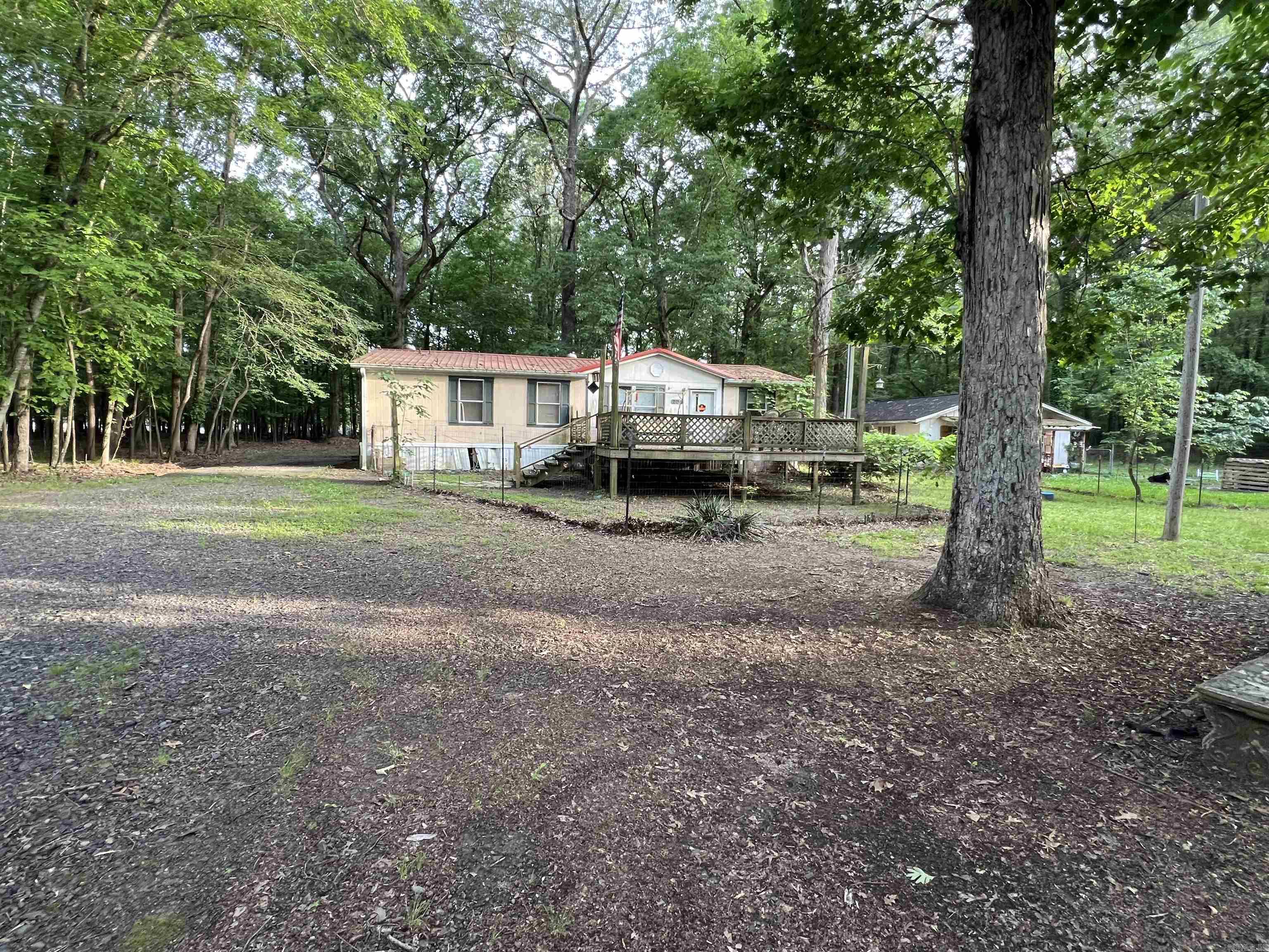 Nice flat lots to build on. utilities on the property. There is a mobile home (double wide) that has no value. If you enter the Mobile Home, you are entering at your own risk. No repair concessions will be given. Approximately 2.5 lots are being sold see photo for lot sizes. New survey is suggested. In the survey it shows Jackson Loop dissecting the lots and this road isn’t there. All lots are connected.