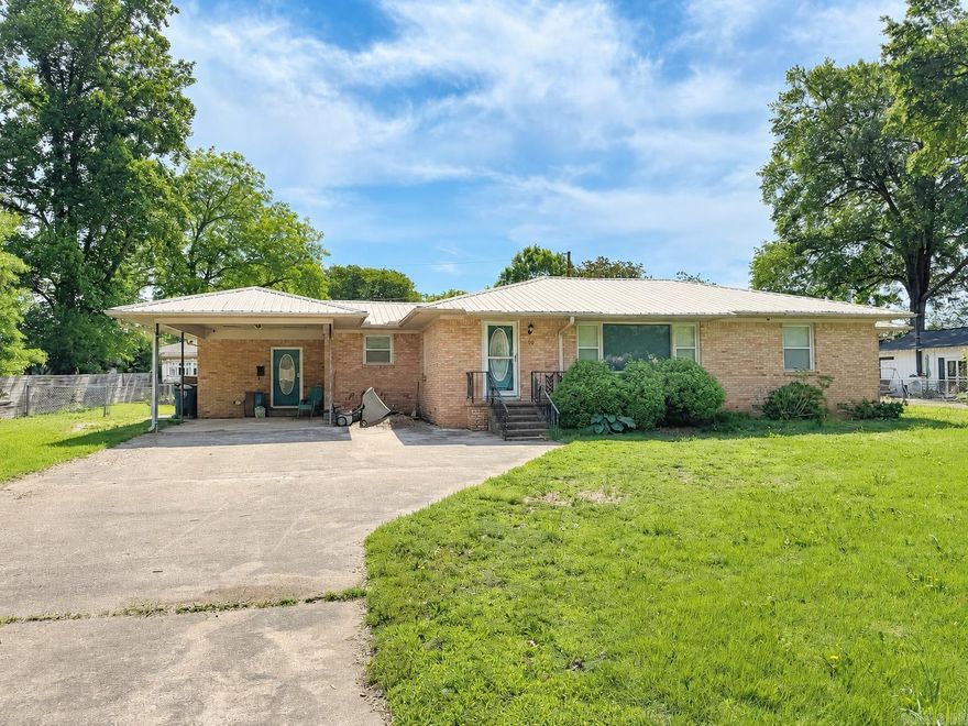 Updated and remodeled 3 bedroom and 3 bathroom home on Searcy's west side.  Fully fenced front and backyard with divider ideal for pets. Metal roof.  Kitchen has ample cabinet and counter space and a gas range.  Refrigerator conveys with the home. There is also a bight and large combination kitchen and dinning room.  The living room also has multiple windows to allow in light with luxury vinyl tile throughout the home. There is a mudroom at the carport entrance and back bedroom/bathroom has a separate side entrance that could have rental income potential.  Gas water heater replaced in 2022 and gas furnace in 2020.  Backyard has a 10x15 shed.