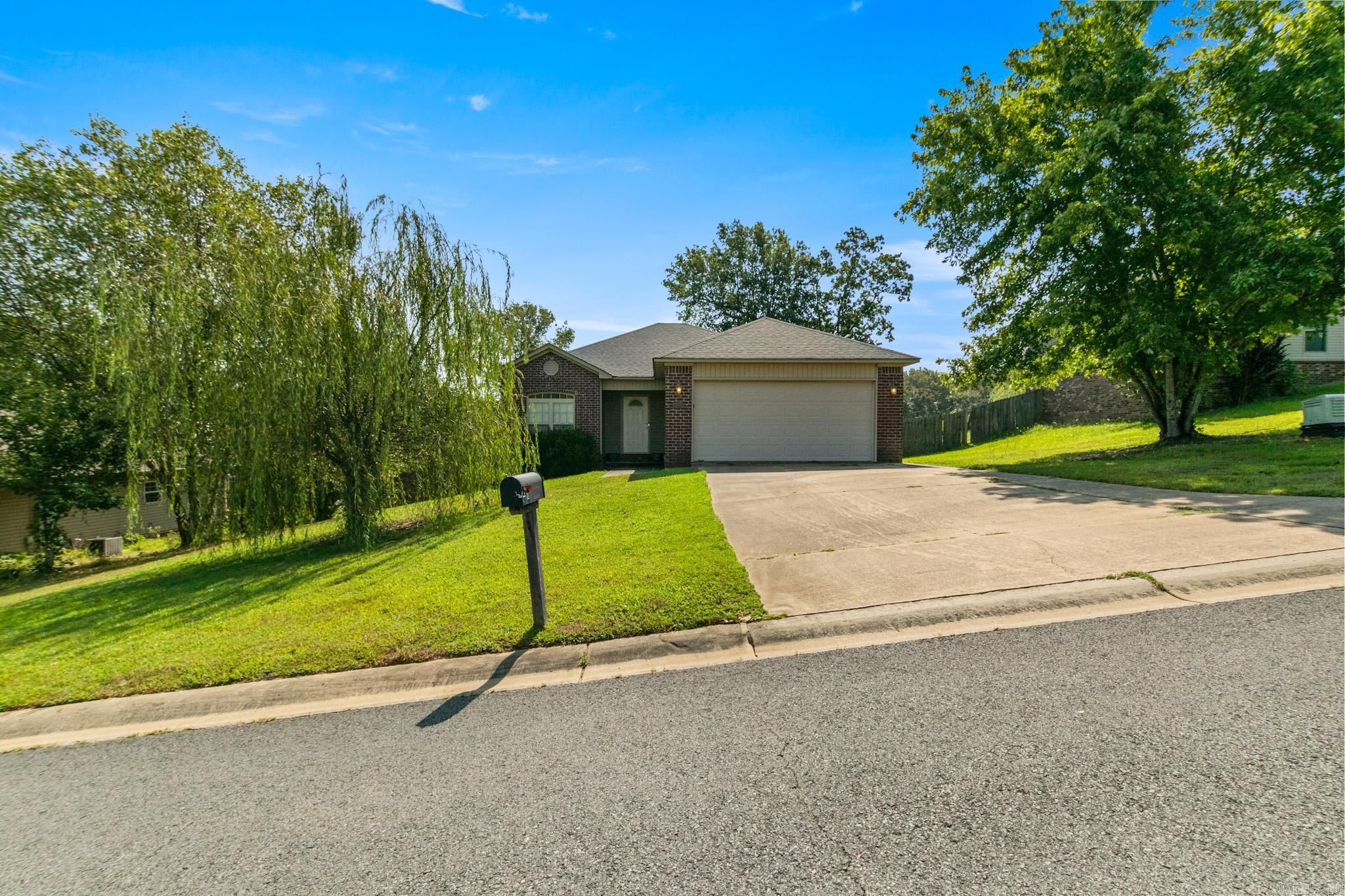 Welcome to this beautifully maintained 3-bedroom, 2-bath home located in a quiet neighborhood just outside the city limits of Cabot, within the sought-after Cabot School District. This home features a split floor plan, spacious living area with vaulted ceilings, and plenty of natural light. The kitchen offers ample cabinet space and a cozy dining area perfect for family meals. The primary suite includes a walk-in closet and private bath with double vanities. Enjoy the large, fully fenced backyard—ideal for pets, kids, or entertaining. With a 2-car garage, covered patio, and a peaceful setting on a 0.30-acre lot, this home has everything you need. Qualifies for RD (zero down) financing!