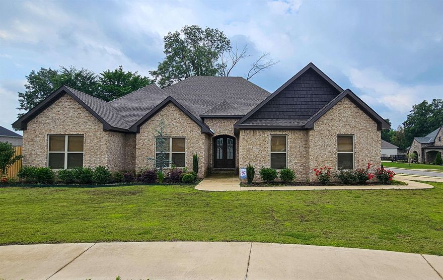 Introducing this exquisite one-level brick home, hitting the market for the first time with over 2,500 sq. ft. of sophisticated living space. Luxury vinyl flooring is found throughout except in the baths that have ceramic tile. A wide entryway welcomes you into a spacious great room, highlighted by built-in shelving and a warm gas-log fireplace. This flows effortlessly into a modern kitchen and dining combo, equipped with solid surface countertops, a large pantry, abundant cabinetry, and an expansive breakfast bar/island—ideal for entertaining. The Primary Suite is a true retreat, featuring a luxurious bath with dual vanities, a freestanding tub, a separate oversized custom-tiled shower, and an exceptionally large walk-in closet. Three additional bedrooms provide ample space and large windows for natural light. The home also includes a convenient laundry room, a full bath, and a guest half bath. Unwind on the screened sunporch, perfect for enjoying rainy days or sunny afternoons in your private, wood-fenced backyard. Located on a generous lot in the Brookland School District.