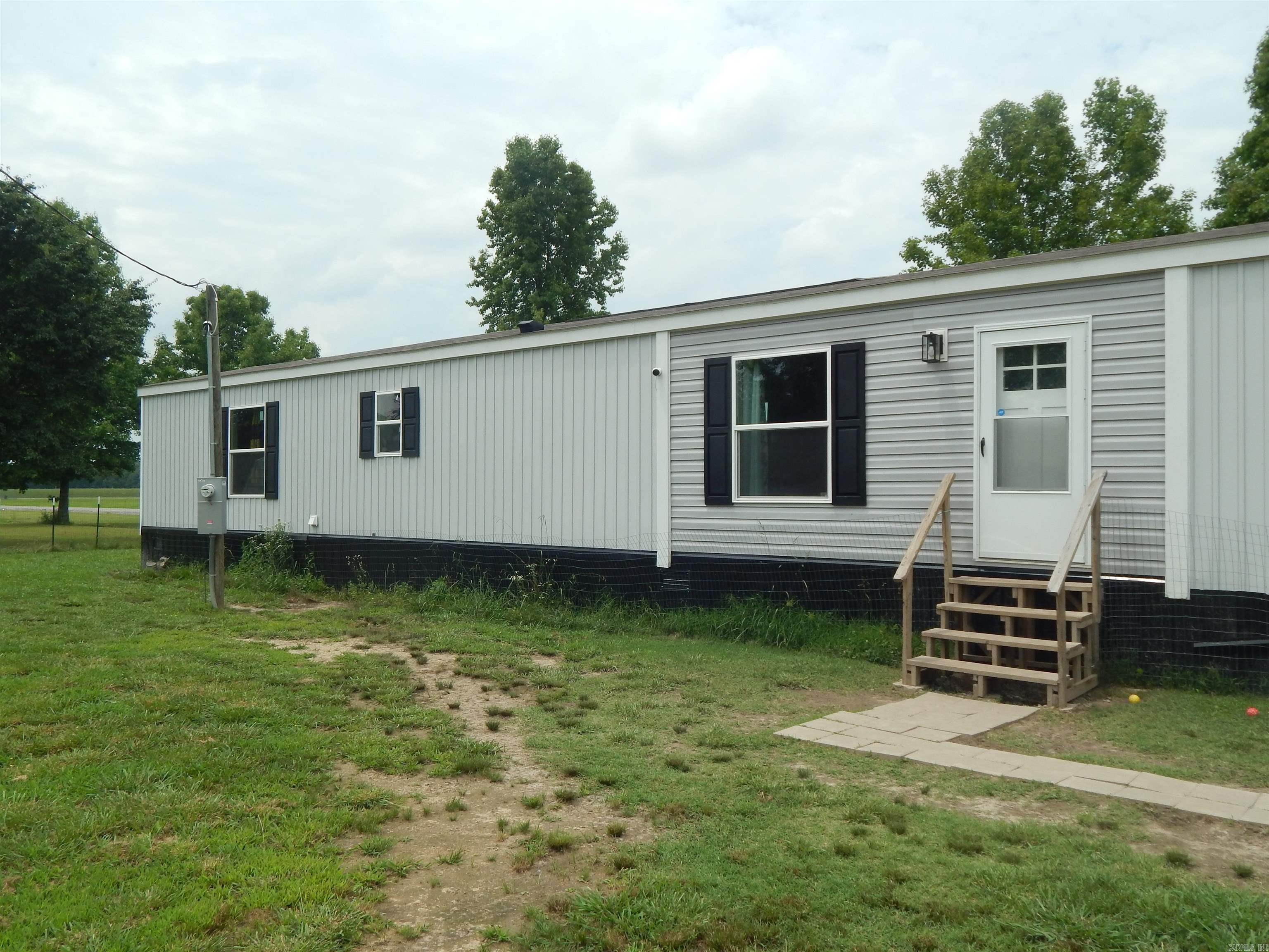 Super nice home. Built in 2023. Neat, Clean and move-in ready. Fenced yard for the puppy. This home was setup right. It has 10 concrete runners and 20 tie downs and should quality for permanent foundation financing. Nice laundry room and coffee bar area and an island in the kitchen. This one is ready to go, don't let it get away. Bonus - This one is located directly across the street from the Higginson City Fishing Lake.