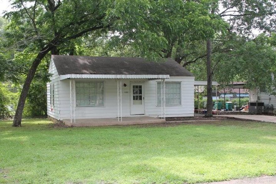 Cute 2 bedroom home close to Arkansas Tech University. This home features the original hardwood flooring, corner lot, and carport with covered parking. Tenant has 11 months remaining on current lease contract.