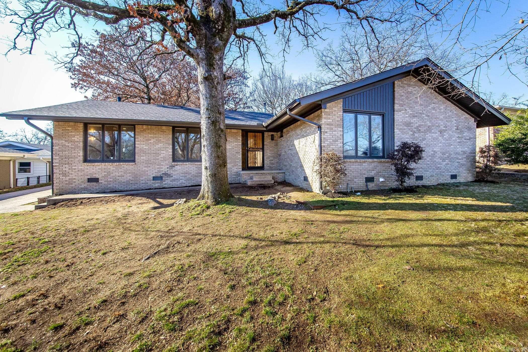 Welcome to 5205 N. Vine St., North Little Rock, a stunning blend of modern updates and mid-century charm. This redesigned 4-bedroom, 2-bath ranch sits on a generous 0.40-acre lot, making it one of the largest in the neighborhood. The fresh exterior creates instant curb appeal, while the rear-entry carport ensures privacy and convenience. Step inside to discover refinished hardwood floors and a stylishly updated interior. The kitchen is a showstopper, featuring brand-new stainless steel appliances, a four-seat island, and modern light fixtures. The bathrooms have been artfully transformed, with the main bath offering a soothing palette and the owner’s suite showcasing bold, mid-century-inspired designs. Outside, enjoy a spacious yard perfect for entertaining, a dog run, and a storage shed for all your needs. This home offers the ideal mix of style, comfort, and practicality. Schedule your private showing today!