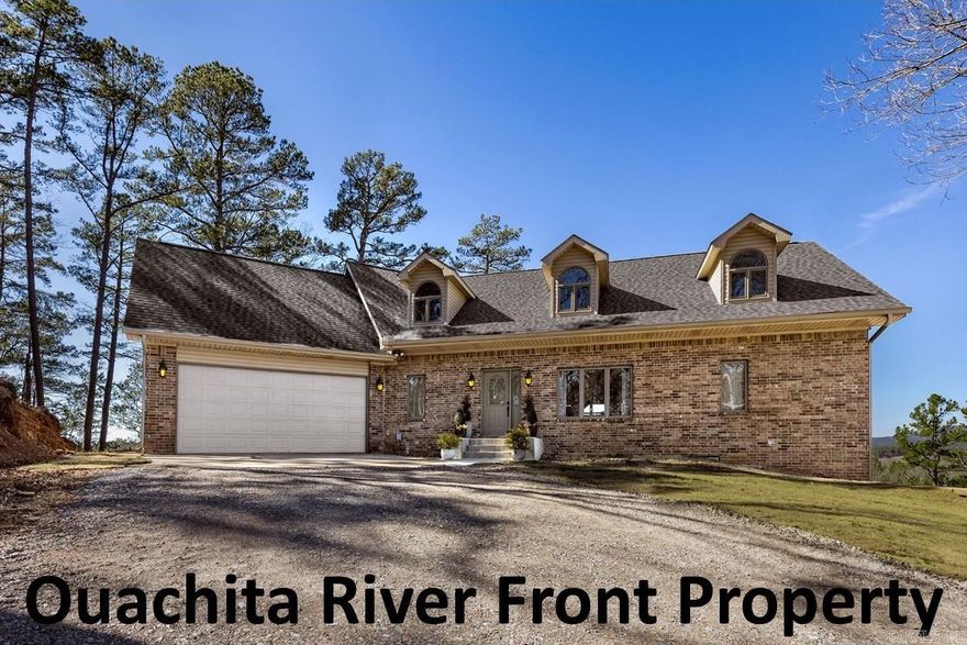 Breath taking views can be appreciated from every angle of this 4326 SF, 3 story home. 38 tree covered acres bordered by Nat. Forest on 2 sides overlook a qtr. plus mile of Ouachita River frontage with gorgeous mtn. views as far as you can see. Rocky cliffs, including 6 acres on opposite bank of river to preserve natural beauty & insure privacy. The gated entry winds along a private road & ends just beyond the 36x40 metal shop. Home exterior is brick, siding, leaf gaurd gutters, Pella windows, lifetime warranted arch. roof & 2 levels of wrap around deck overlooking this amazing view. Main level: 1/2 guest bath at study & entry, open to 2 story den with WBFP, updated eat-in kitchen, laundry & exit the 2 car garage. Master suite completes this floor. Upstairs: 2 beds, guest bath, hall closet, & bonus room - could be 5th BR or game room. Downstairs: utility storage, access to 2 water heaters, softner & PH regulator plus HVAC. 2nd den with WBFP, 3rd full bath & 4th BR. Bedrooms are supersized, all granite countertops & tile in bathrooms & laundry. Stocked pond, stone chimneys with slab wood mantles, 2 commercial ht. over head doors on shop. Super maintained. See online docs