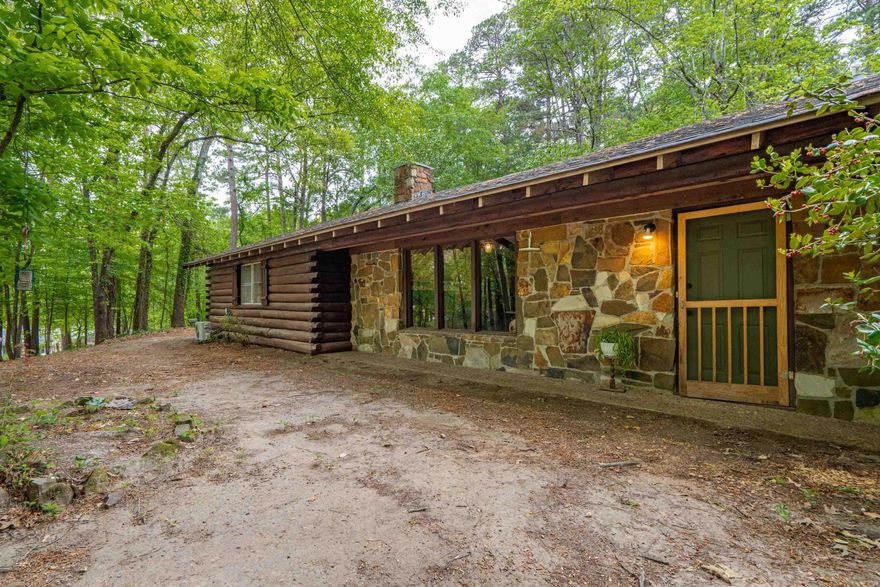 Unique log home offering privacy and character, situated on approximately 1 acre within city limits. Perched on a hill, this property provides a secluded feel and lovely views, while remaining conveniently located.  The home features 3 bedrooms and 2 remodeled bathrooms, along with a vaulted living room showcasing exposed beams. Recent updates include all new luxury flooring and a new roof installed in 2023. The exterior has a 25-year stain for long-lasting durability. A versatile bonus/flex space (approx. 13.5 x 17.5) includes built-in shelving, a mini-split system, and a private exterior entrance—ideal for an office, hobby room, or guest space, or additional bedroom.  Additional features include a commercial-grade water heater, storm cellar, and an outdoor water feature that enhance the setting.