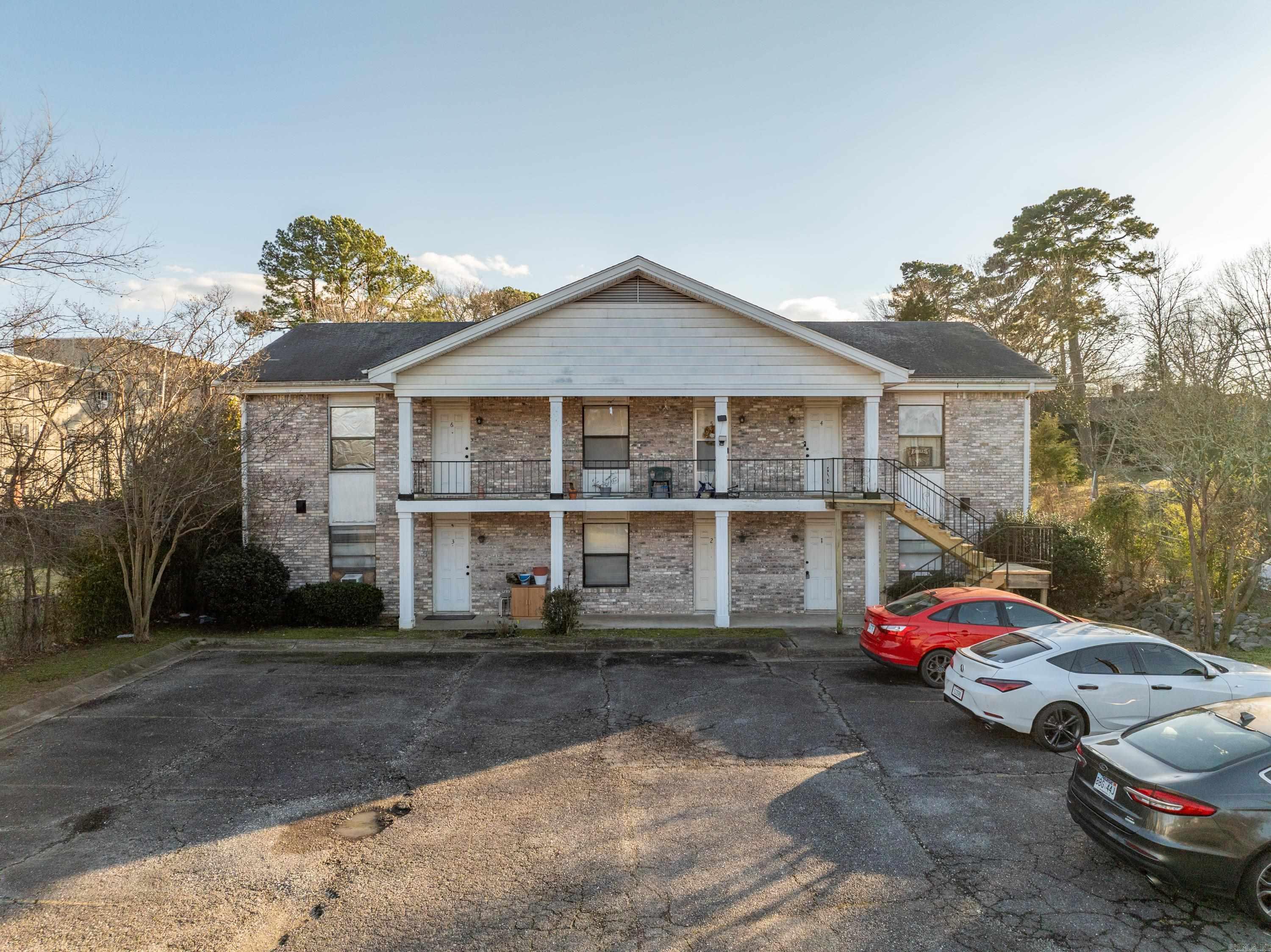 This is a wonderful rental complex--It is Fully occupied and 1 resident has been there 12 yrs! It's very close to Bus Routes, Downtown Hot Springs and the Bypass. Owners provide water/trash and lawn service and tenants provide everything else... Out of state owners are going in a different direction and have decided to sell. RENT ROLL AVAILABLE TO QUALIFIED BUYERS! Fully occupied, 3 upstairs and 3 downstairs units...All are 1 Br 1 Bth--Many renovations have been done, including paint, flooring, several appliances and several HVAC systems--New Iron and Wood stairs to the top 3 units were built in 2024. All units are Central Heat and Air. Each unit has 2 Entrances, 1 on the parking lot side and 1 on the Manor Cir side. ALL 9' CEILINGS.. Very Nice Tenants in place that always pay on time and cause no issues! 24 HR NOTICE FOR ALL SHOWINGS