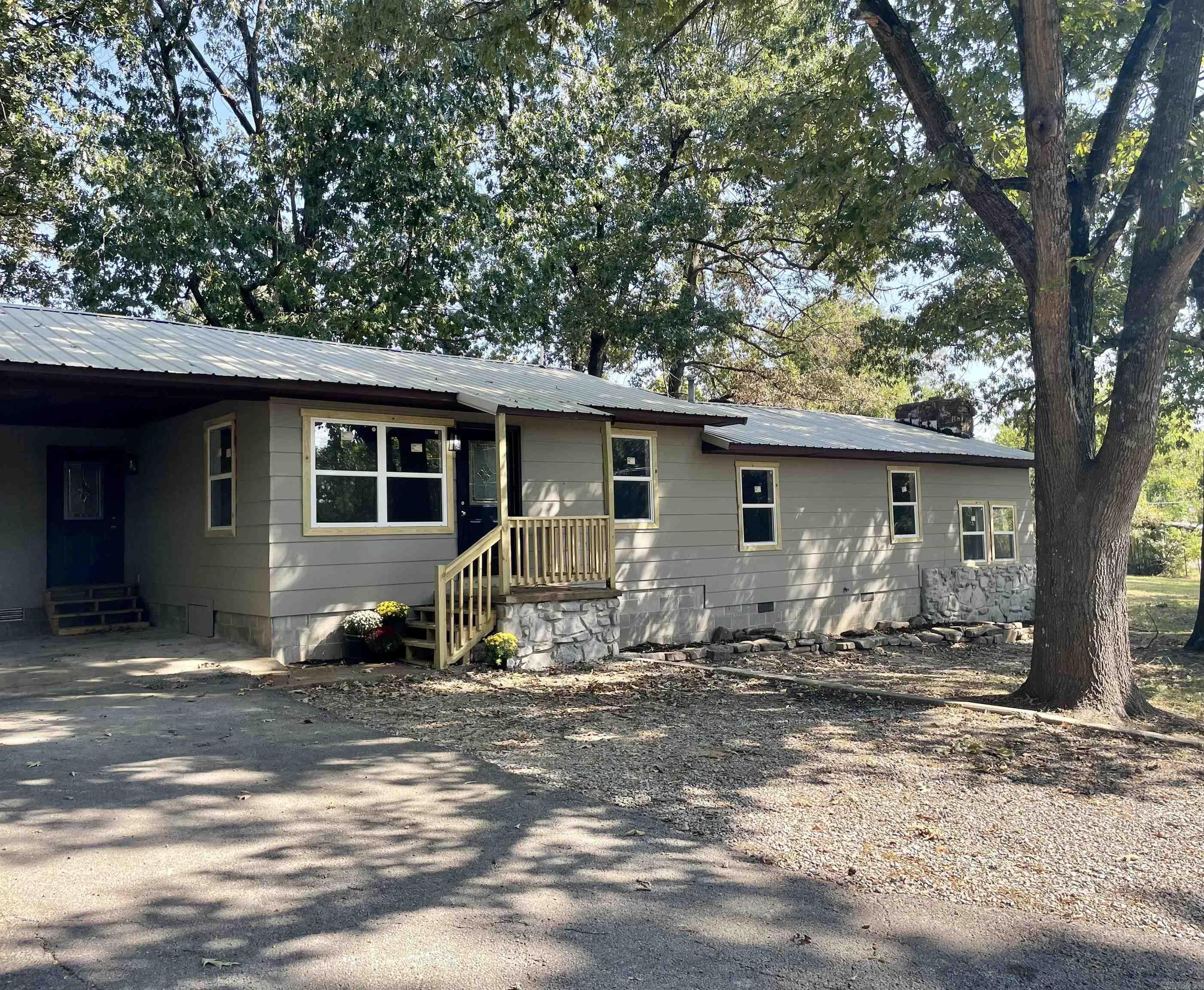 This beautifully remodeled home has 1674 sqft+/- of living space with 3 ample sized bedrooms and 2 full baths in a split-level floor plan. The main living area is adorned with beautiful hardwood floors and provides an unobstructed view of the dining area and kitchen. The masterfully remodeled kitchen features stylish new cabinetry, and the butcher block counter tops add to the aesthetic. Just off the main living area you will find a quaint home office space. The first of the full baths is easily accessed from the main living area. All 3 bedrooms are situated on the split level. All feature new carpet and plenty of closet space. The second full bath shares this level, as well as the large laundry room. Finally, the sunken second living area provides extra space for entertaining and features a rock fireplace that is plumbed for a gas insert. Just off the kitchen and dining area through the French doors you will find a large wood deck perfect for outdoor entertaining. This home has been updated with new windows, electric, plumbing and new HVAC. All of this sits on a quiet dead end road in the heart of Pocahontas.