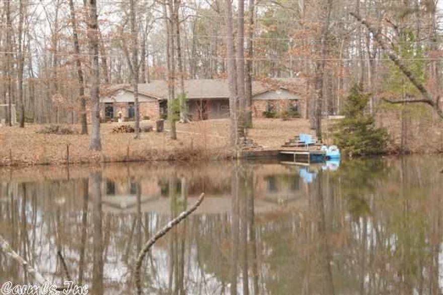 WOW! OH! WOW!  Country living just minutes to everything.  Bryant and I-30.  Formal living room and dining.  Family room with fireplace.  Large kitchen with lots of storage.  Shop and pond with biggest fish I ever saw.  All brick on 5 acres with many updates. some wallpaper being removed and painting being done**see agent remarks