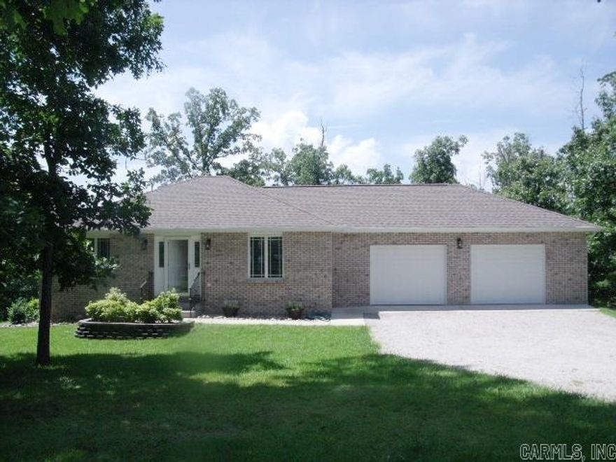 STUNNING 3BR/2BA BRICK AND VINYL home with walk out basement.  This beautiful home sits on 4 lots (3 acres m/l) with woods on either side in quiet neighborhood.  Gas (propane) heating, water heater and stove.  GE appliances, hickory cabinets in kitchen.  Composite decking.  The attention to detail in this home must be seen!