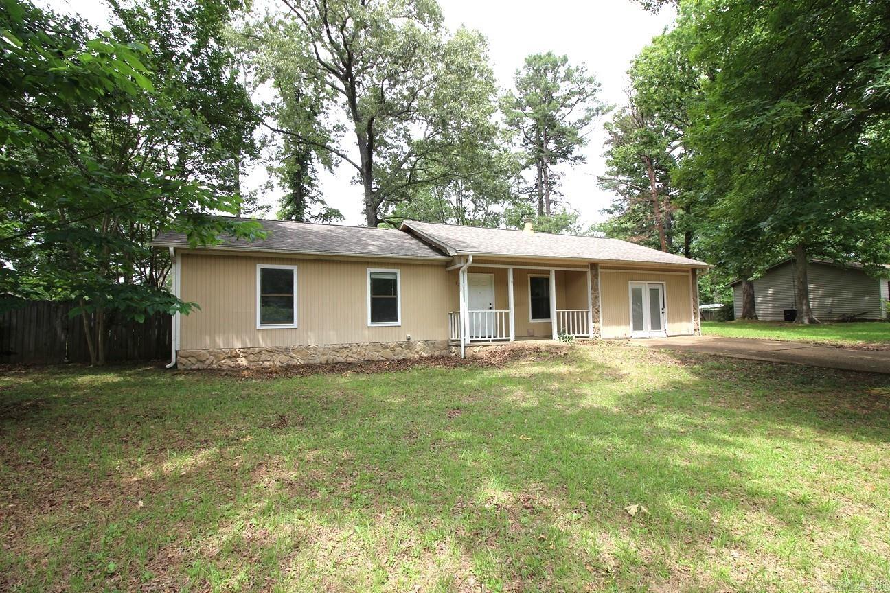 Located outside the city limits on a quiet street. 3/2 LSSD, level privacy fenced back yard & garage converted to living should mean a good fit for a family. Open kitchen/living/dining with a rock wood burning fireplace. Granite tile kitchen counter tops. Tile flooring in kitchen, baths, dining, living room & hall. Tile shower/bath surround in hall bath. Newer carpet in bedrooms. Patio, front porch, gutters, architectural shingle roof. Gas central heat & gas hot water heater. Refrigerator conveys.