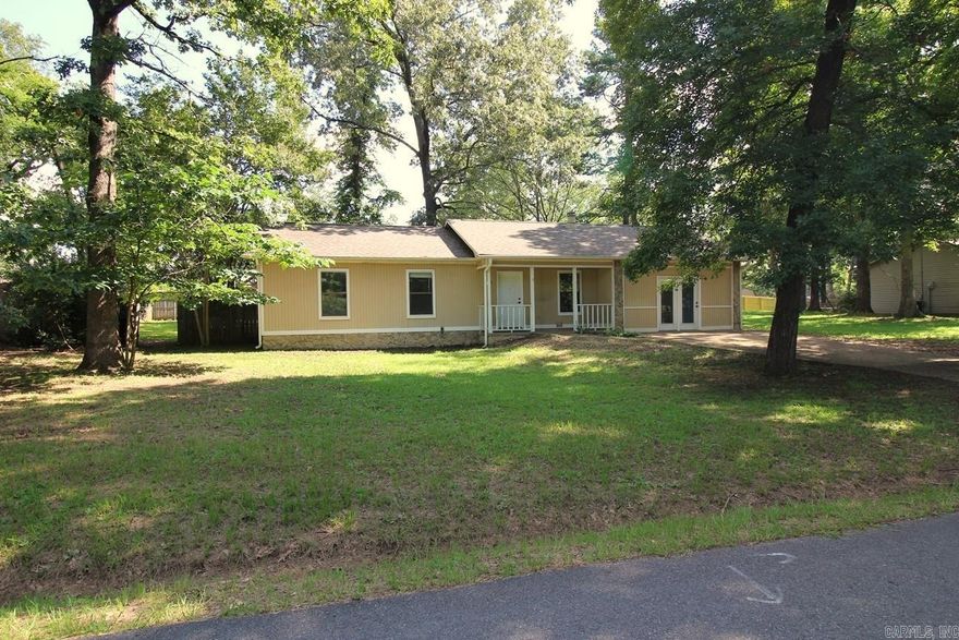 Located outside the city limits on a quiet street. 3/2 LSSD, level privacy fenced back yard & garage converted to living should mean a good fit for a family. Open kitchen/living/dining with a rock wood burning fireplace. Granite tile kitchen counter tops. Tile flooring in kitchen, baths, dining, living room & hall. Tile shower/bath surround in hall bath. Newer carpet in bedrooms. Patio, front porch, gutters, architectural shingle roof. Gas central heat & gas hot water heater. Refrigerator conveys.