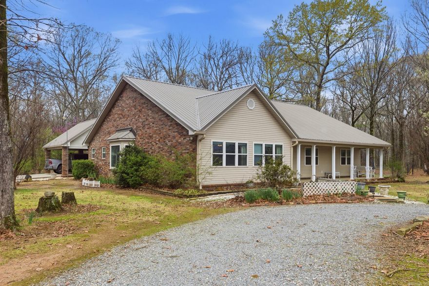 Rare opportunity to own a 3,123 sq ft ranch home on 20.79 wooded acres with two large workshops and multiple covered storage areas—perfect for hobbyists, equipment storage, small business use, or outdoor enthusiasts. The property features a 40x50 workshop with electricity and a 40x30 workshop with water, electricity, and loft, plus additional covered carports for vehicles, trailers, boats, or ATVs. this well-maintained two-owner home offers 3 bedrooms, 3 bathrooms, multiple living areas, and scenic country views throughout the main living and dining space. The open kitchen includes a center island, generous workspace, and seating area for casual meals. Outdoor living includes a covered front porch, covered back patio leading to a fenced yard, and covered parking connected to the home by breezeway. Metal roof with gutter protection. The 20.79 wooded acres provide privacy, space to roam, and excellent potential for hunting or recreation, all while offering comfortable living and incredible workshop facilities. Furniture negotiable.