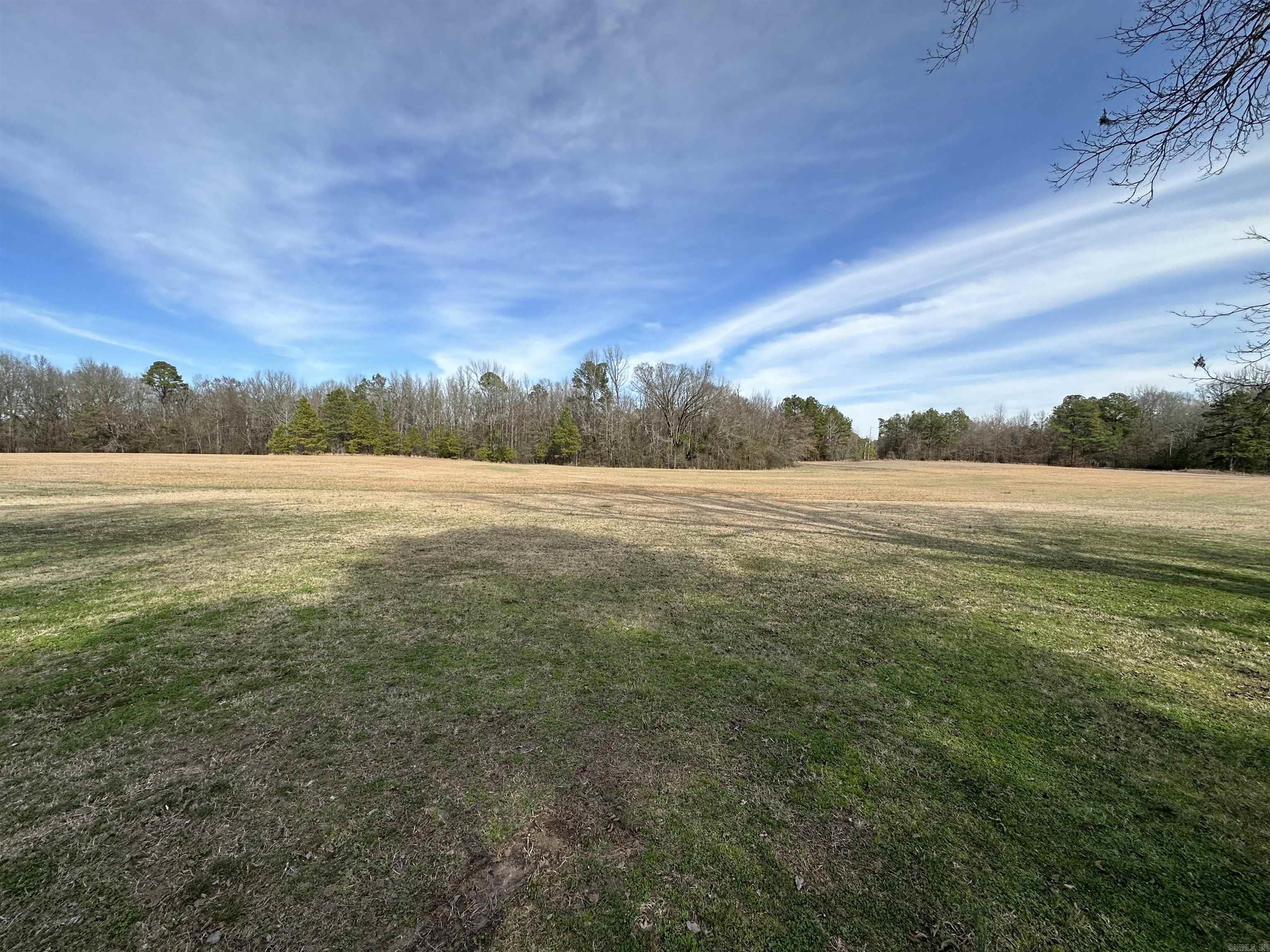 Open land ready to build, or farm. Just minutes from town, spring fed pond and nice home site.