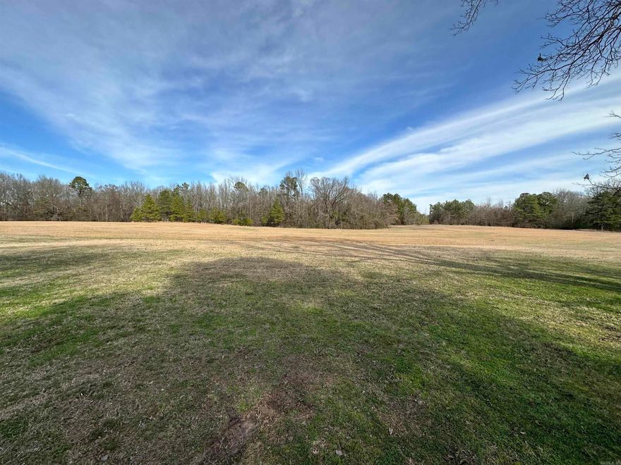 Open land ready to build, or farm. Just minutes from town, spring fed pond and nice home site.