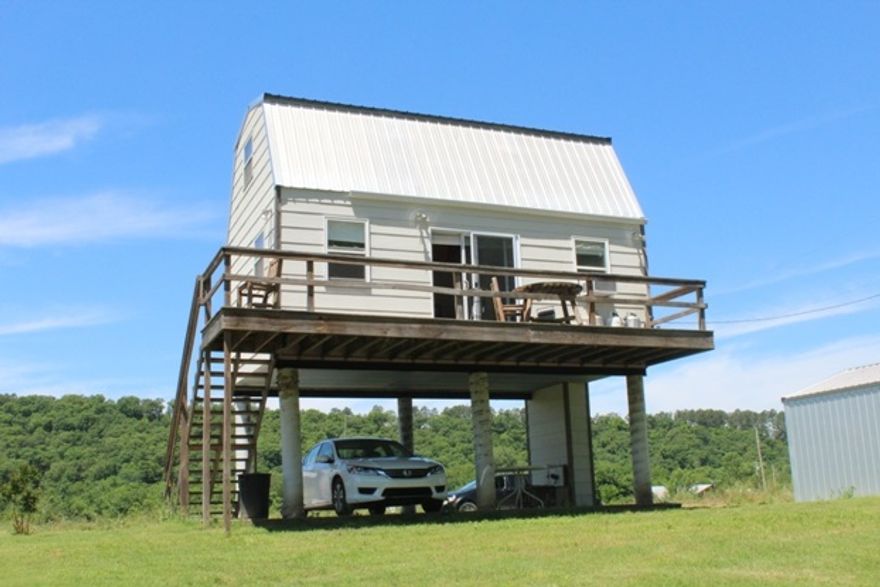 No.01454 “TINY” HOME ON WHITE RIVER FOR SALE Don’t miss this one of a kind opportunity. Enjoy the White River and everything the Ozarks have to offer for half the price. Thinking you can’t afford a second vacation home. Now you can! This 336 square foot home will sleep 6-8 people. The home has propane heat, propane water heater, and a propane range making it incredibly efficient and having no worries with a power outage. The home is located on the bank of the White River for a great view and summer fun.