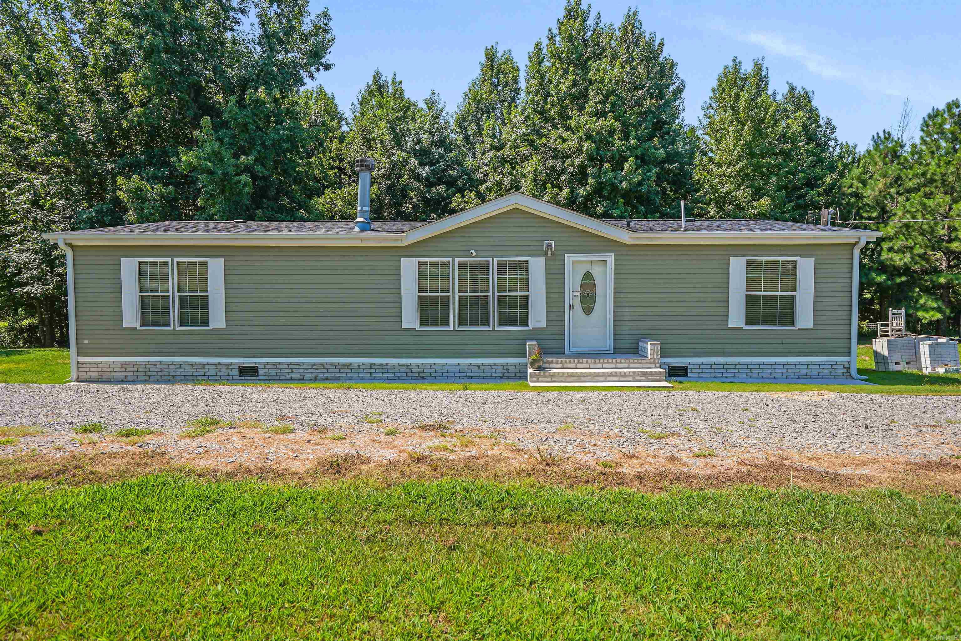 Check out this Vilonia stunner on almost 2 acres! This home was beautifully updated to satisfy your desires. NEW roof, NEW floors, NEW paint, NEW deck, NEW skirting, NEW sidewalk and stairs, NEW gutters, NEW blinds, NEW kitchen. This home is located on a quiet road, and with 1.9 acres of land you'll have plenty of privacy. All-Electric appliances and a wood-burning fireplace in the living room to neatly adorn the space. This clean and move-in ready home features a split floor plan with a his and hers closet in the primary bedroom. Enjoy the large soaker tub and walk-in shower in the primary bathroom. This home has its own laundry room and a spacious pantry to compliment the kitchen! On a permanent foundation. This is the home you've been looking for under $200k!! Call now to schedule your private tour.