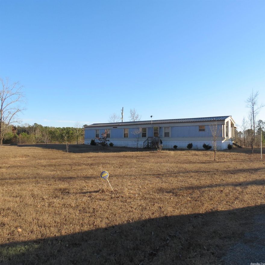 Affordable country living!!  This single wide mobile home is ready for a new owner.  Bring your clothes and groceries, that is all you need.  There is furniture staying.  This 3 bedroom 2 bath home has all appliances in the kitchen and the washer/dryer is staying too!  Back porch.  This home sits on 3.2 acres of cleared land.  Great shop with 2 roll up doors and walk thru doors with electric on a slab.  Call today to schedule a tour. Zero taxes after homestead credit.