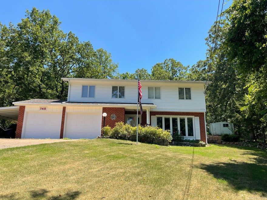 Completely remodeled and updated to today's style, this beautiful lakeview home sits directly across the street from Lake Sequoyah and offers comfort, character, and exceptional outdoor living. This tri-level home features 2 bedrooms, 2.5 baths, and a spacious primary, along with a thoughtfully updated interior showcasing granite countertops in the kitchen, renovated baths, hardwood flooring, Anderson windows and doors, and abundant storage throughout. Improvements include a new roof in 22 and a dual-fuel heat pump for year-round efficiency. The inviting living area includes a fireplace with gas logs, creating a warm and cozy atmosphere. Outside, the beautifully landscaped yard is designed for entertaining and relaxation with a large back patio, extensive stone walls, and charming walkways
