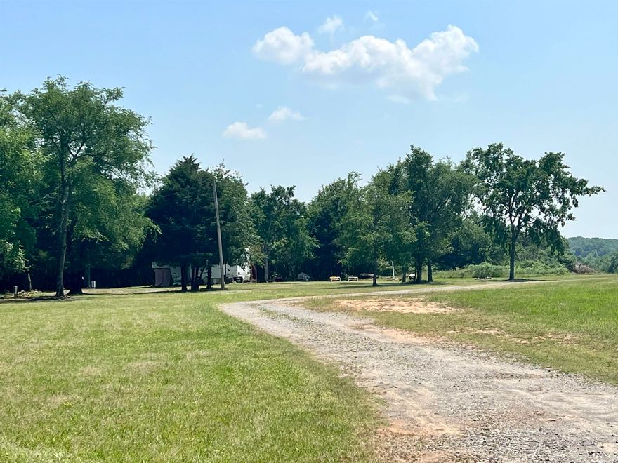 Very nice potential INCOME PRODUCTING property with THREE RV spots located on site.  They have previously been rented for $375 per month per seller with seller paying Electric and water.  Beautiful building spots located on the land, overlooking a bluff and creek. Pipeline runs across property, you can not build any structures on right of way.