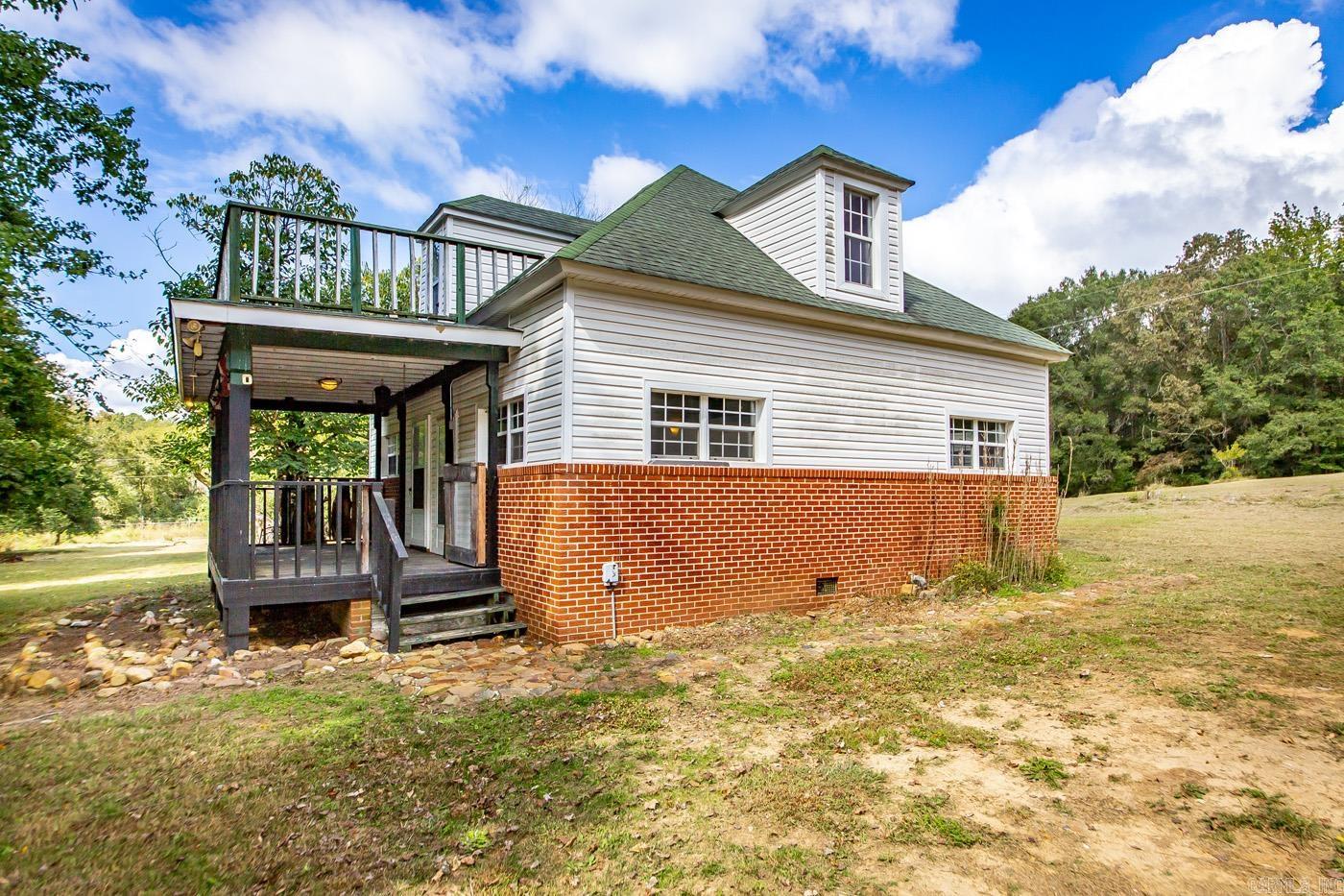 Located in the country near Mena, this home sits on 10 acres of partially wooded land, providing added privacy and open space. The property offers flexibility for buyers, who can purchase all 10 acres, split the acreage, or choose a combination of land and home. Light-filled, open living areas offer functional space, and versatile rooms can be adapted to fit your needs. The yard provides room for outdoor activities, gardening, or additional structures. With its convenient location, country setting, and flexible acreage options, this property presents a rare opportunity for those seeking space and privacy.