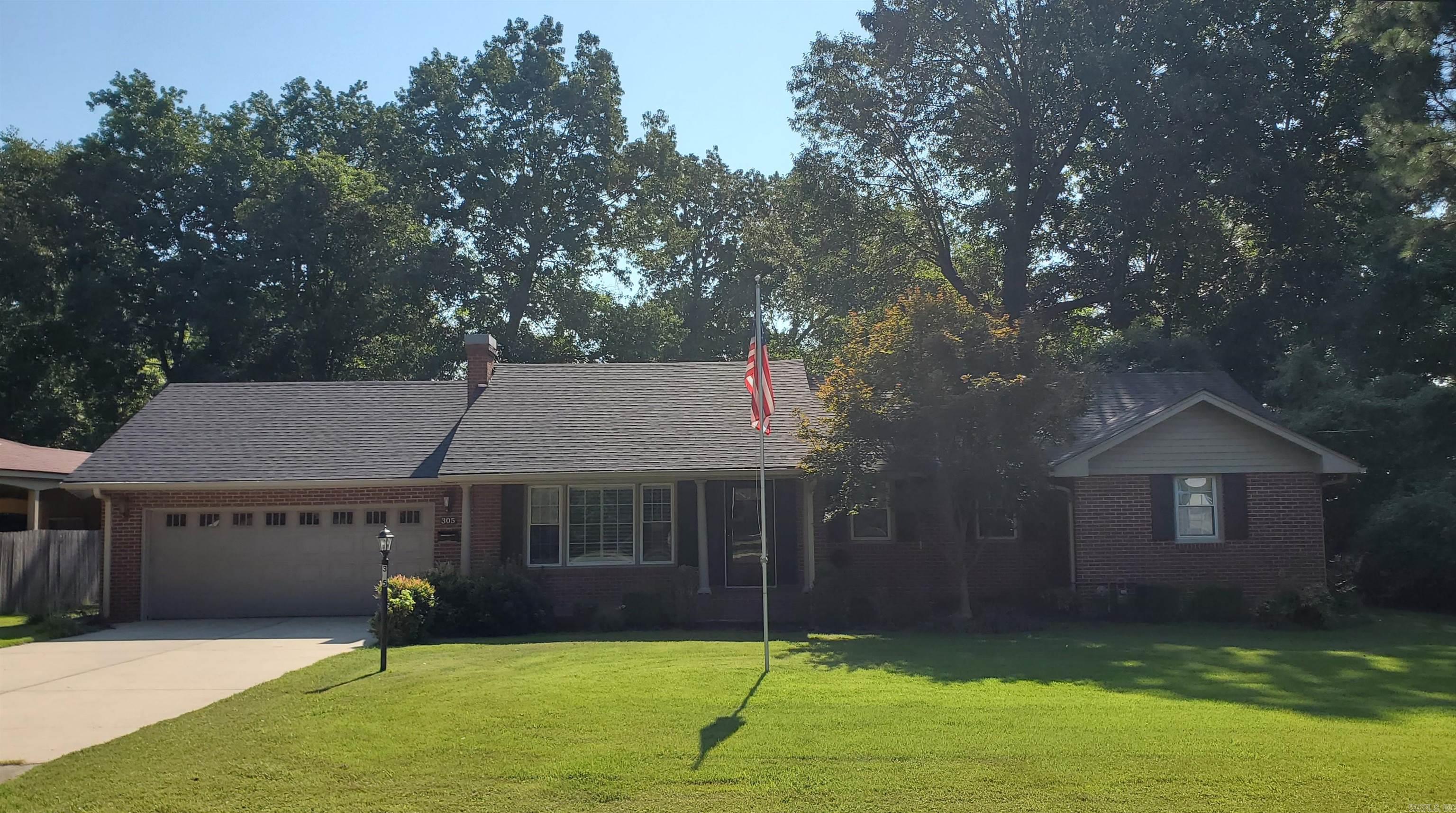 Welcome home to this charming brick residence nestled in Piggott, AR. Step inside to a spacious and inviting floor plan featuring four generously sized bedrooms and two full bathrooms - perfectly suited for growing families or guests. The brick exterior offers timeless curb appeal and low-maintenance durability. The interior highlights hardwood and modern laminate flooring throughout, a bright living area with large windows, and a kitchen-dining room combo, ample cabinetry, and stylish countertops. The primary suite offers a peaceful retreat complete with its own private deck and an en-suite bathroom--ideally designed for comfort and convenience. The property also offers a separate bonus/family room, covered patio and private back yard space ideal for relaxing or entertaining. The exterior features a classic brick facade, well maintained landscaping and a two-car garage. Located in peaceful, friendly neighborhood close to schools, hospital and community amenities--305 N 8th Ave is a dream come true!