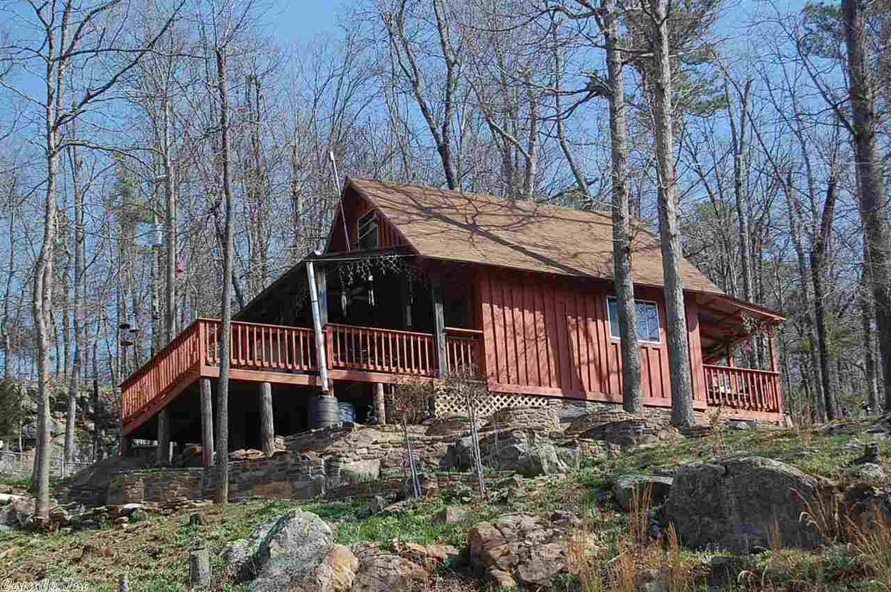 Enjoy this unique getaway. 2 story cabin on almost 10 acres in the heart of the Ozark Mountains. Breath taking views of the year round creek that runs by the cabin will have you sleeping like a baby, on the large deck in back on those lazy summer days. Take a nice stroll on the bridge that crosses the creek or hunt for arrow heads by the bluffs. Cabin is furnished and ready to go. New 1000 gallon septic and rural water recently installed. Plenty of wild life, deer, turkey and an occasional black bear.